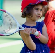 Young children learning to hold a tennis racket