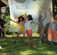 Young children performing a play outside