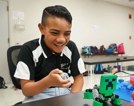 Child building LEGO robots in the style of Minecraft characters