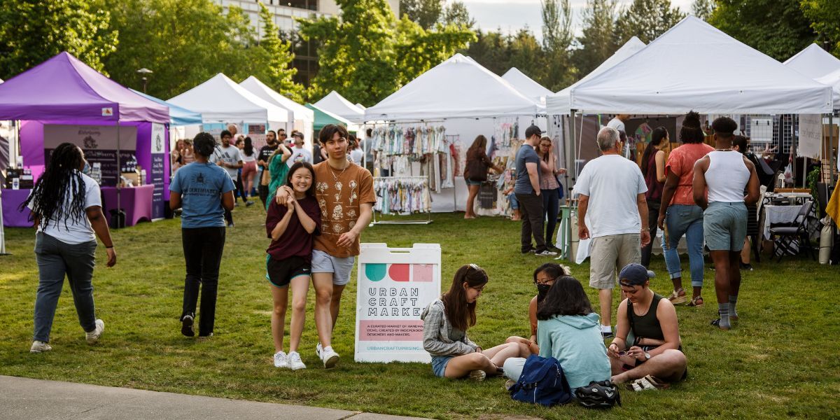 Hundreds of attendees exploring a pop-up tent craft market