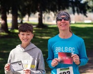 Two top finishers at Beat the Bunny holding award certificates