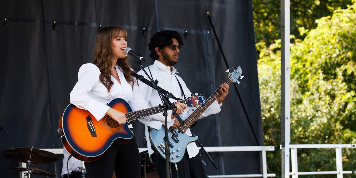 Musician playing an acoustic guitar on stage