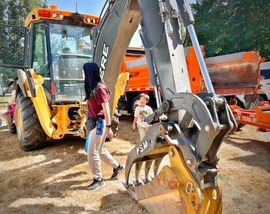 Child exploring a large construction machine
