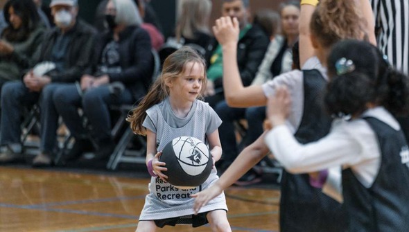 young child playing basketball