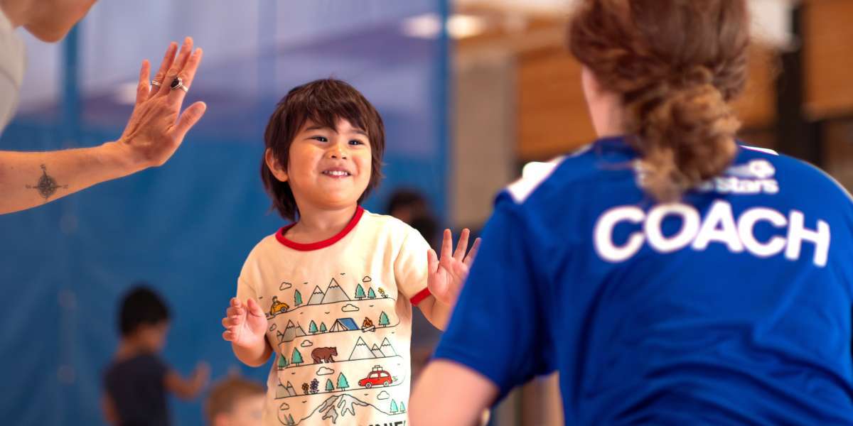 Young child high fiving their soccer coach