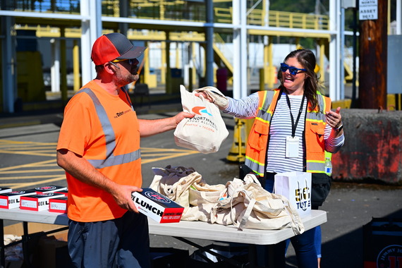 staff hands out lunch and information to truckers on a terminal