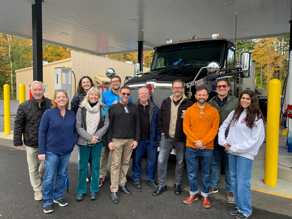 the clean and prosperous team in front of a truck