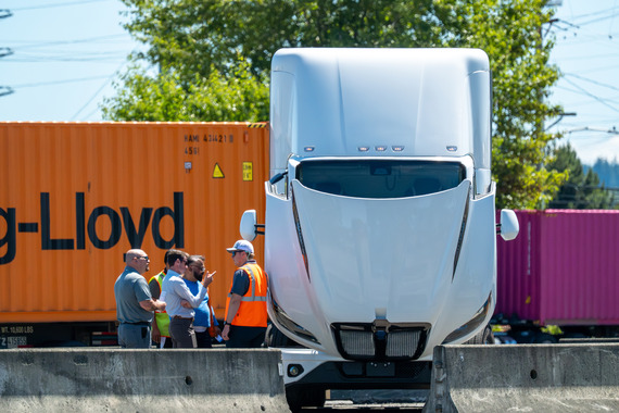 a zero emission truck on a port terminal with the hood liftedc