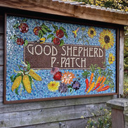 mosaic tile artwork featuring images of fruits, flowers, vegetables and the words "Good Shepherd P-Patch"