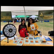 Preparedness brochures at table staffed by two people