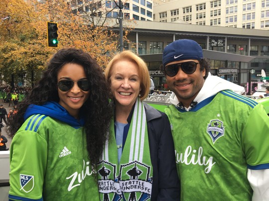 Mayor Durkan poses with Russell Wilson and Ciara at the Sounders FC parade and celebration