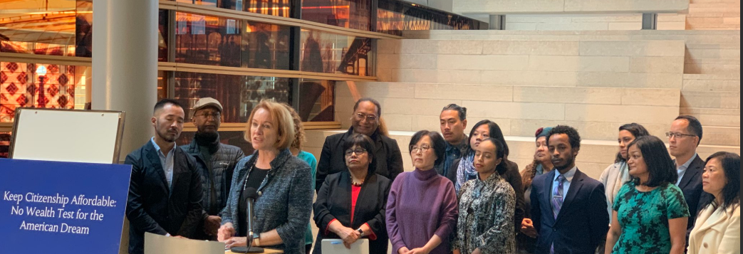 Mayor Durkan, Rep. Jayapal and others stand at a press conference condemning the Fee Waiver rule