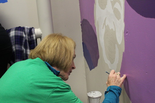 Mayor Durkan paints details on a mural of Dr. Martin Luther King, Jr. at Concord Elementary School