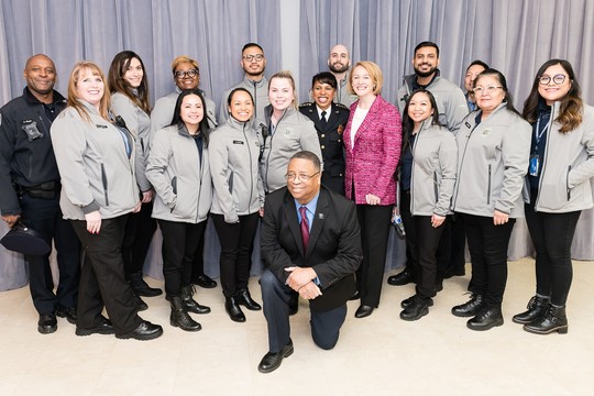 Mayor Durkan, Chief Carmen Best, and Former Councilmember Larry Gossett pose for a photo with SPD Community Service Officers