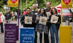 Young adults at Northwest Folklife holding flyers