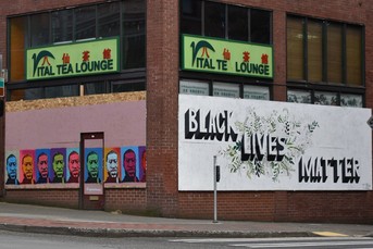 Southeast corner of Jackson and Maynard, with murals on both sides of Vital Tea storefront. 