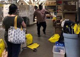 Staff inspecting a community service work site inside a warehouse