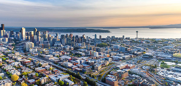 Bird's eye view of Seattle with Puget Sound in the distance.