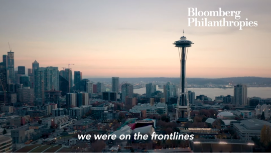 image from Bloomberg video showing the Seattle skyline against an orange sky 