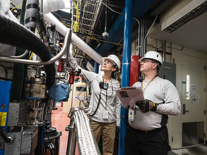 Two inspectors reviewing machinery 