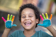 Happy Preschooler with Painted Hands
