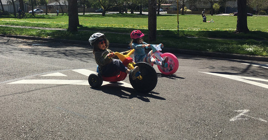 Children play in the neighborhood street on their bikes