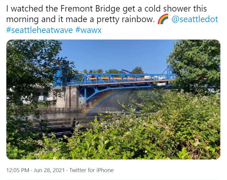 Photo of Fremont Bridge being watered, that creates a rainbow
