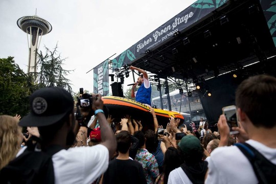 Seattle rapper Sol rides an inflatable raft in the crowd at the Fisher Green Stage on the first day of Bumbershoot at Seattle Center