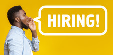 Man making announcement with text that says HIRING over yellow background.