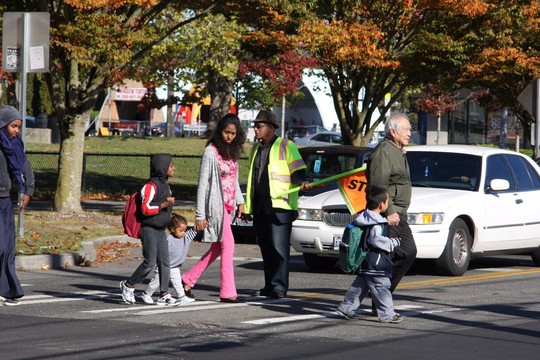 Children and families using a crosswalk