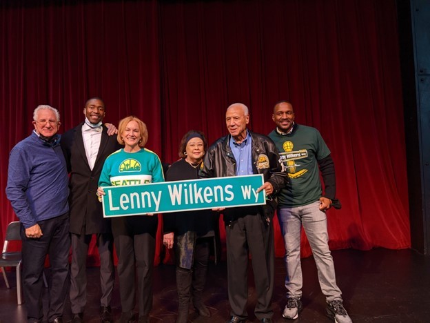 Mayor Durkan, Lenny Wilkens, and others pose with the Lenny Wilkens Way sign