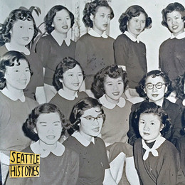 A vintage photo of a group of young Chinese American women, smiling. 