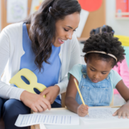 Child care provider reading to a child. 