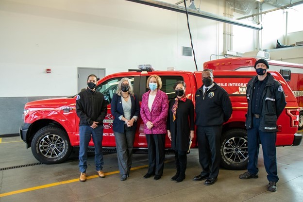 Mayor Durkan and speakers in front of  a mobile health unit