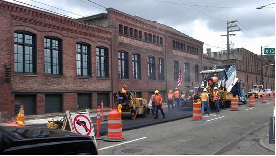Construction crews working to pave the street. 
