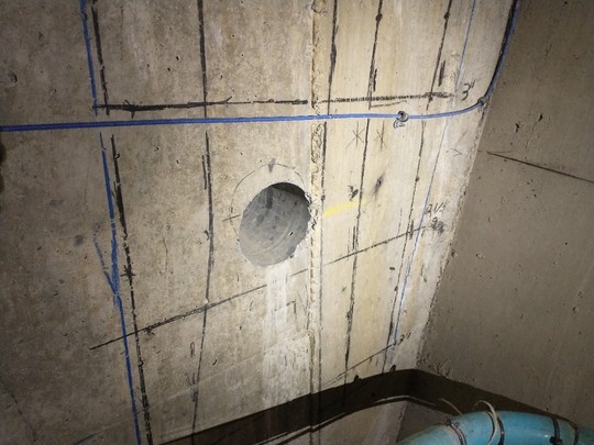 A hole drilled through 17 feet of concrete in the interior of the high bridge in preparation for utility relocation
