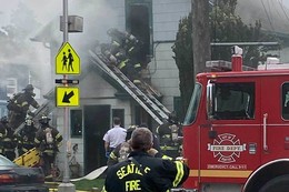 Firefighters rescue woman from burning home