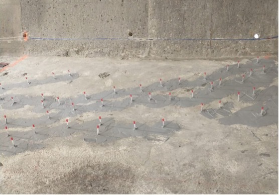 We pumped epoxy through the red-tipped ports at high pressures to fill cracks in the concrete. 