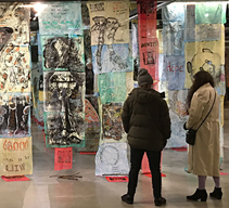 Two people exploring The 1 Million - Multiple Species Eradication exhibit at King Street station