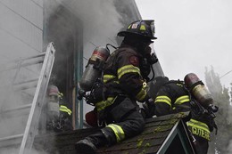 Firefighters rescue woman from burning home