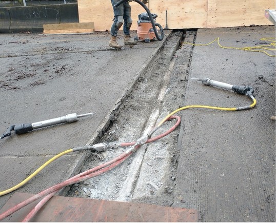 Chipping away and cleaning old expansion joints on the bridge. 