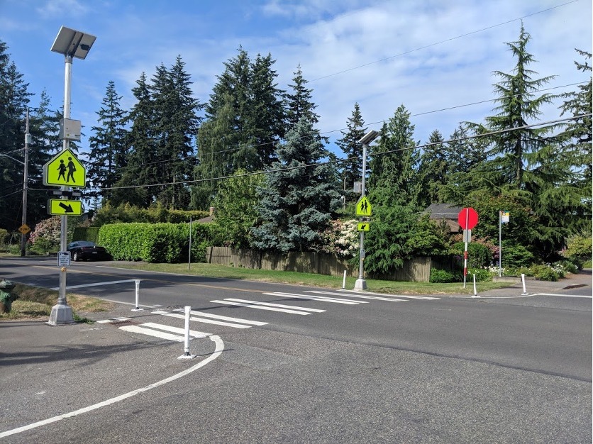 A flashing crosswalk beacon installed at a crosswalk. 
