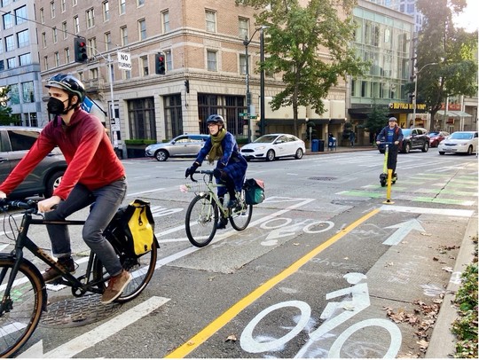 Biking on a protected bike lane on 4th Ave in downtown Seattle 