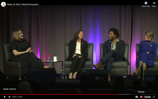 City Attorney Davison, Marc Dones, and Councilmember Nelson sit on stage across from Brandi Kruse, smiling and laughing