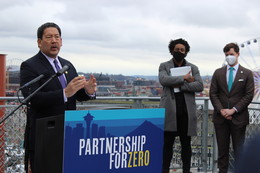 Mayor Harrell speaks at Partnership for Zero launch, with RHA CEO Marc Dones and CM Andrew Lewis behind him