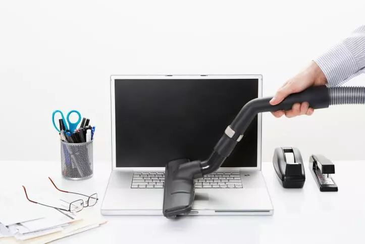 Laptop being vacuumed