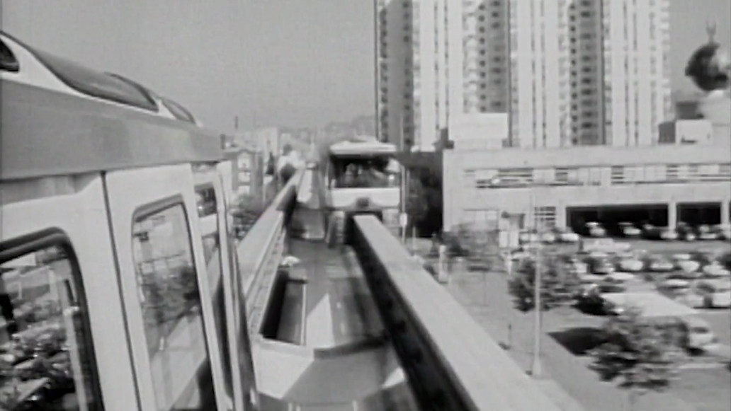 Vintage photo of Seattle Monorail showing one train moving away, one coming towards