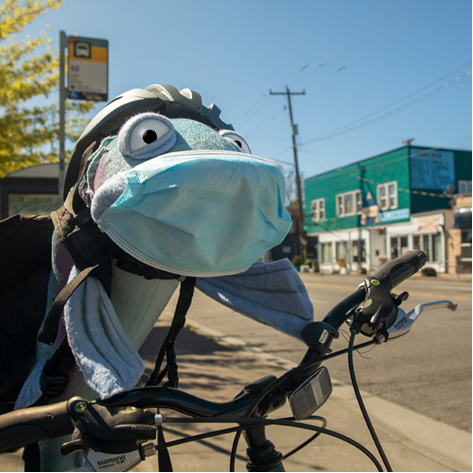 Sal the Salmon enjoys a bike ride during Bike Month.