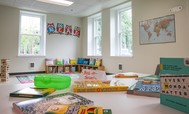 Back to School corner with books and games awaiting children to arrive in a child care facility at housing in Magnuson Park. Photo by Pavel Verbovski.