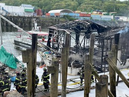 Firefighters extinguish fires on boats docked near the 6300 block of 1st Ave S